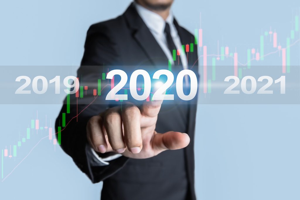 man touching the year 2020 with Stock graph. Concept of niche marketing for success