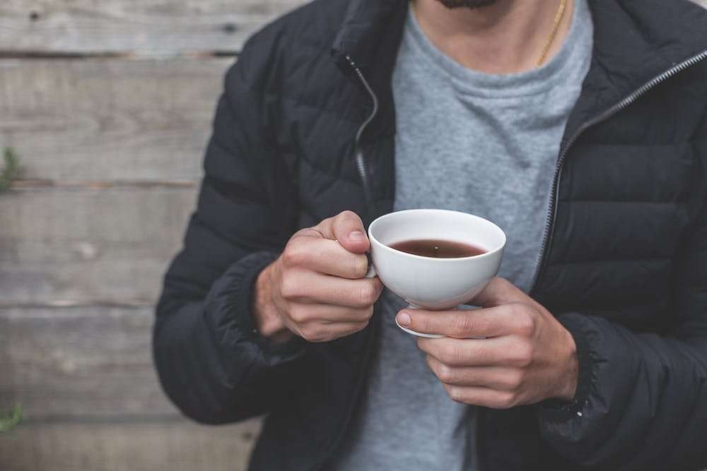 man with cup of black coffee